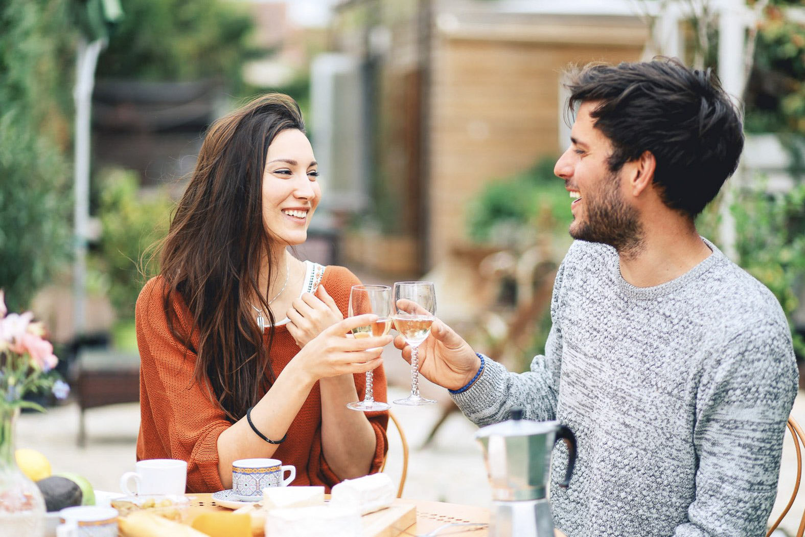 Young French couple having a brunch in the garden