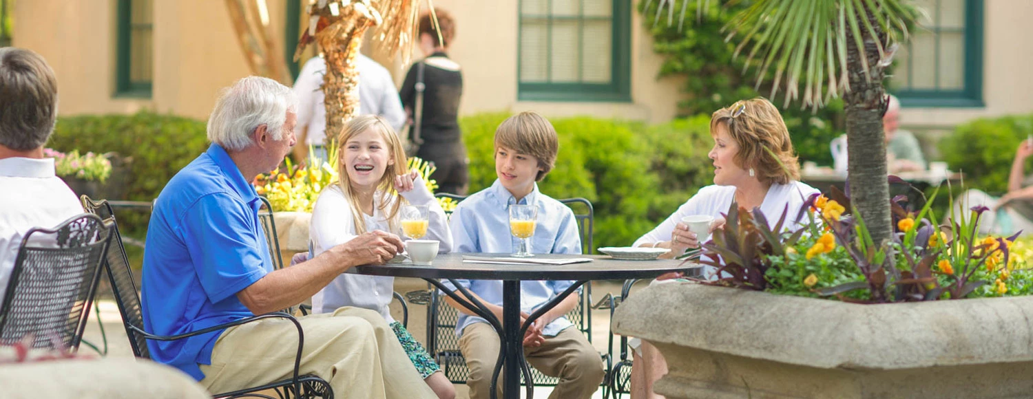 a family sitting on the patio