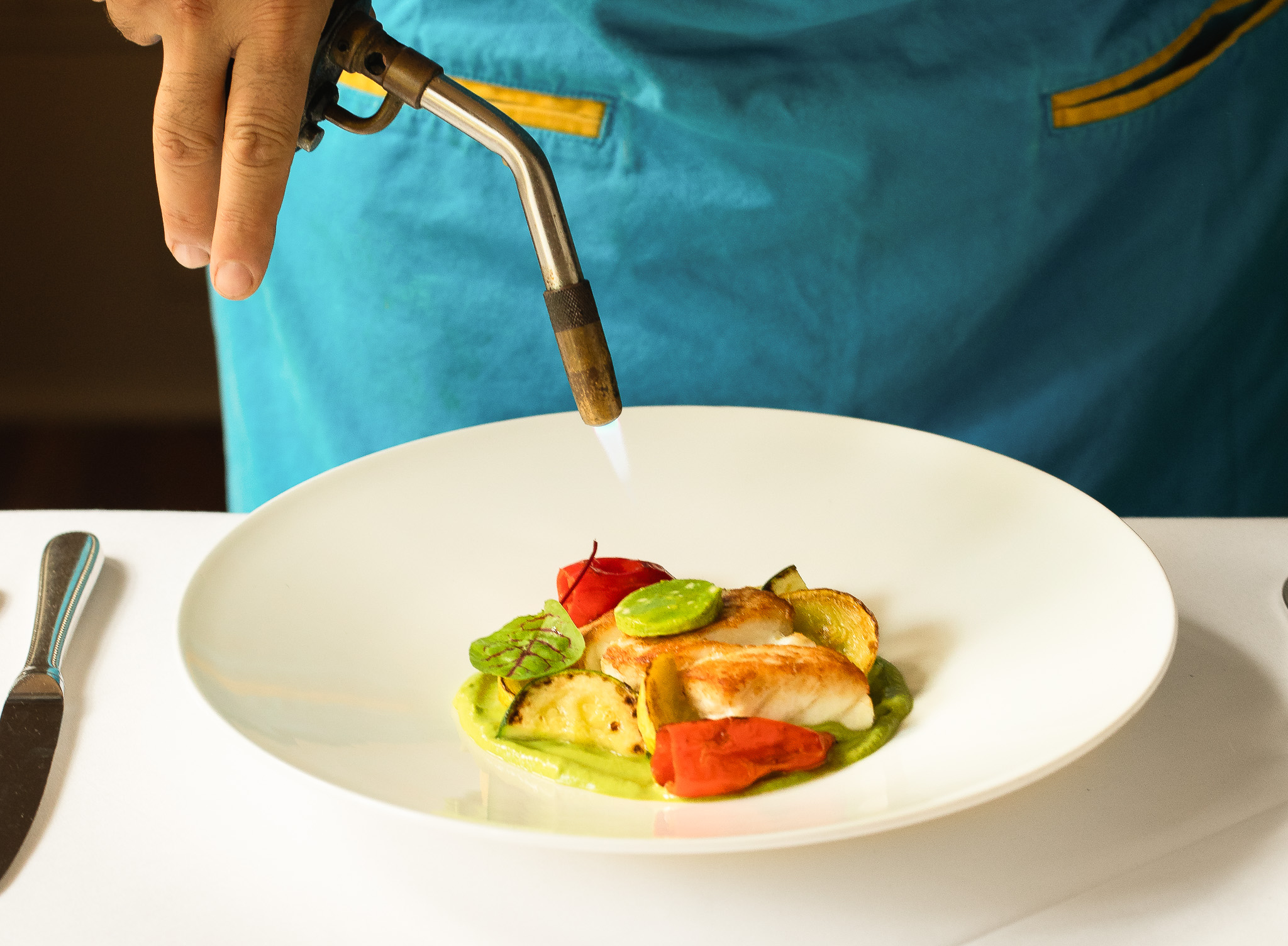 Chef Marc Collins plating a dish at Circa 1886